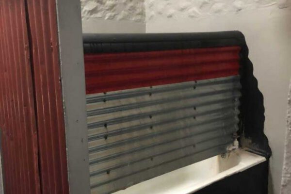 A red-trimmed serving hatch set into a cream wall