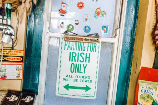 A hand-painted “Parking for Irish Only” sign on a green door
