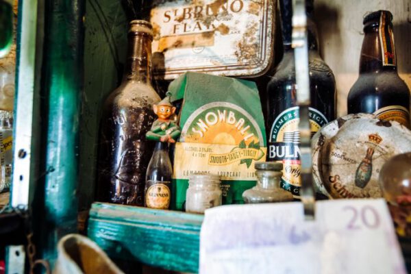 Bottles and beer mats lined along a shelf above the bar