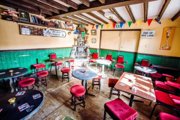 The main bar room with red-topped stools and small tables