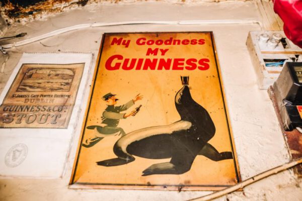 A vintage Guinness poster showing the sea lion balancing a glass