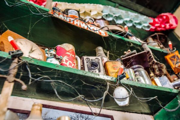 Christmas lights strung above a shelf of ornaments