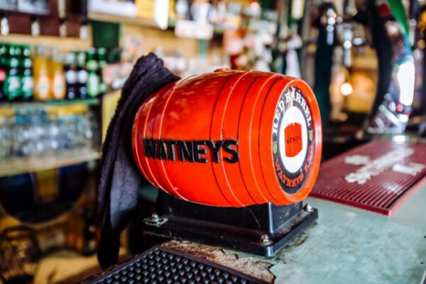 The orange Watneys barrel sitting on the bar counter