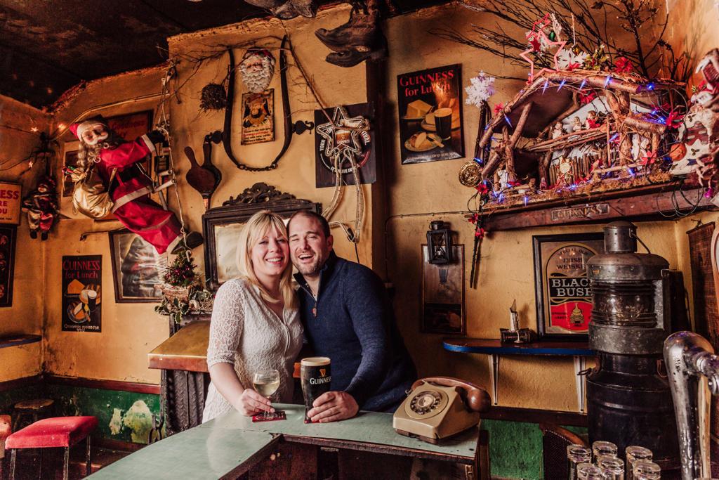 Neasa and Tadhg Kelly behind the bar in The Shanty, surrounded by memorabilia